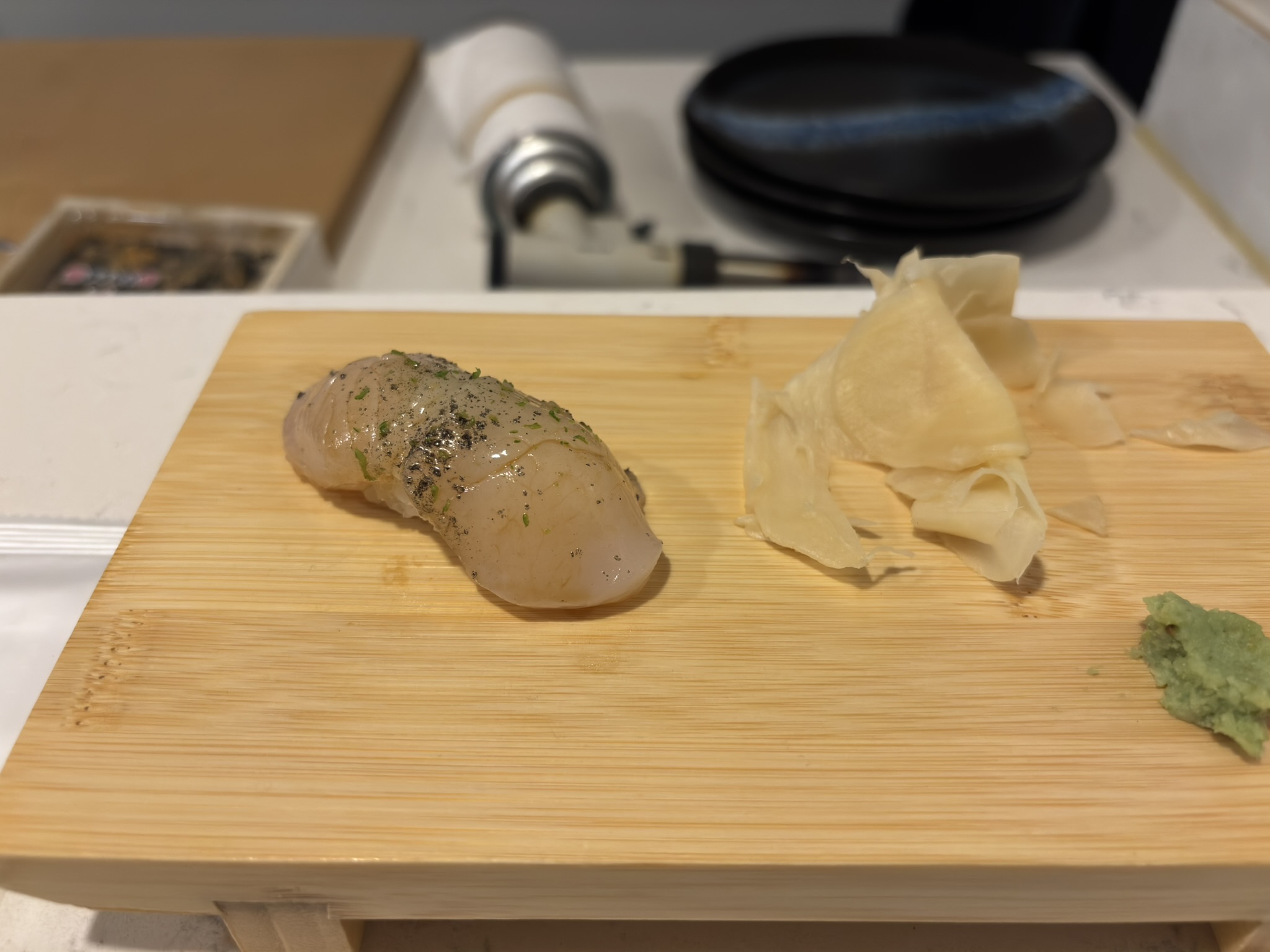 White fish nigiri seasoned with herbs at Shinzo Omakase