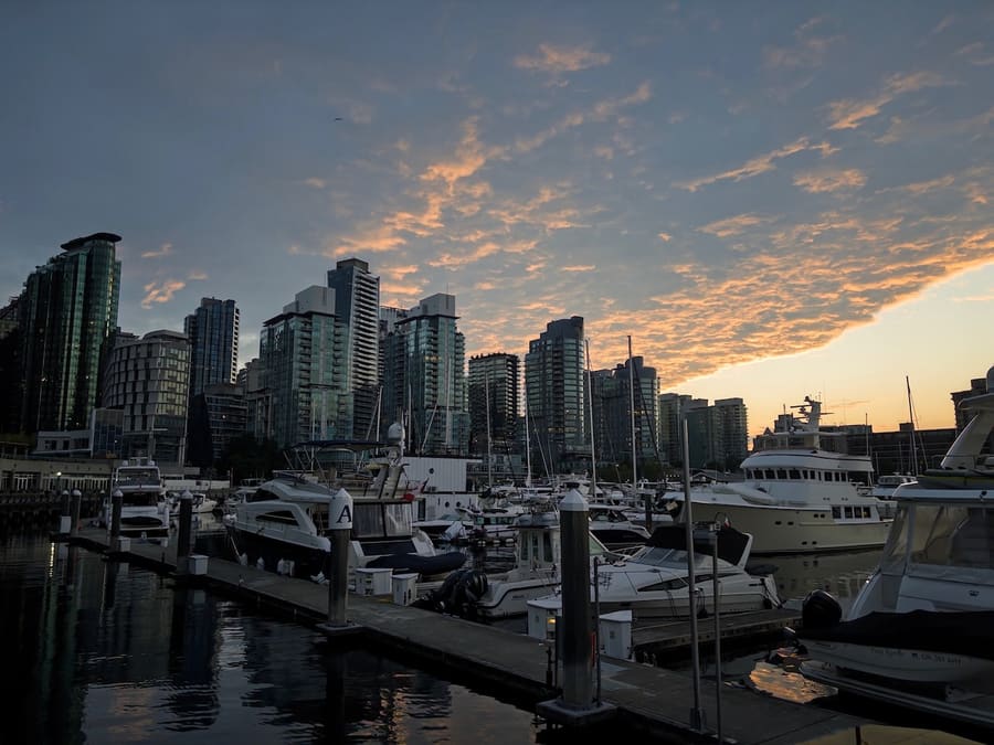 Vancouver skyline and marina beneath a sunset sky