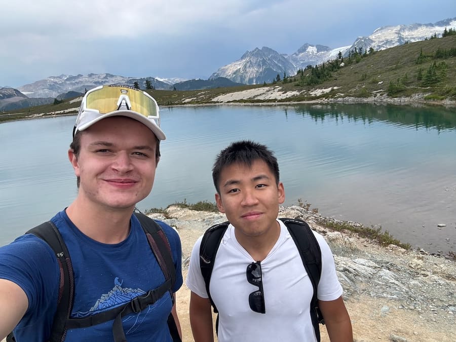 Friends beside an alpine lake in Garibaldi Provincial Park
