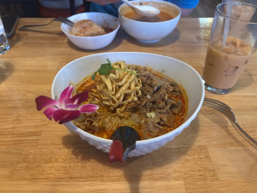 Khao soi noodles served with Thai iced tea