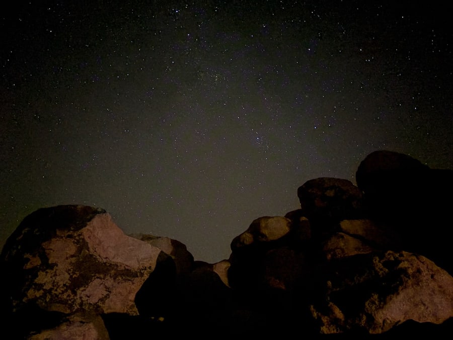 Stars above silhouetted desert boulders