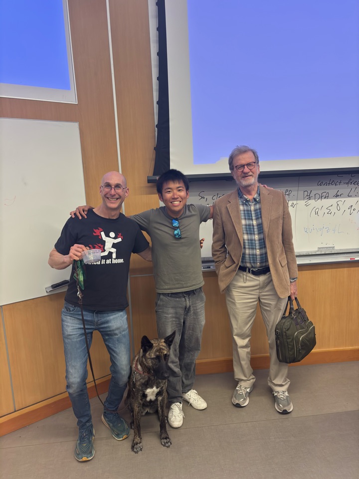 Alan with professors and a dog in a UCLA lecture hall