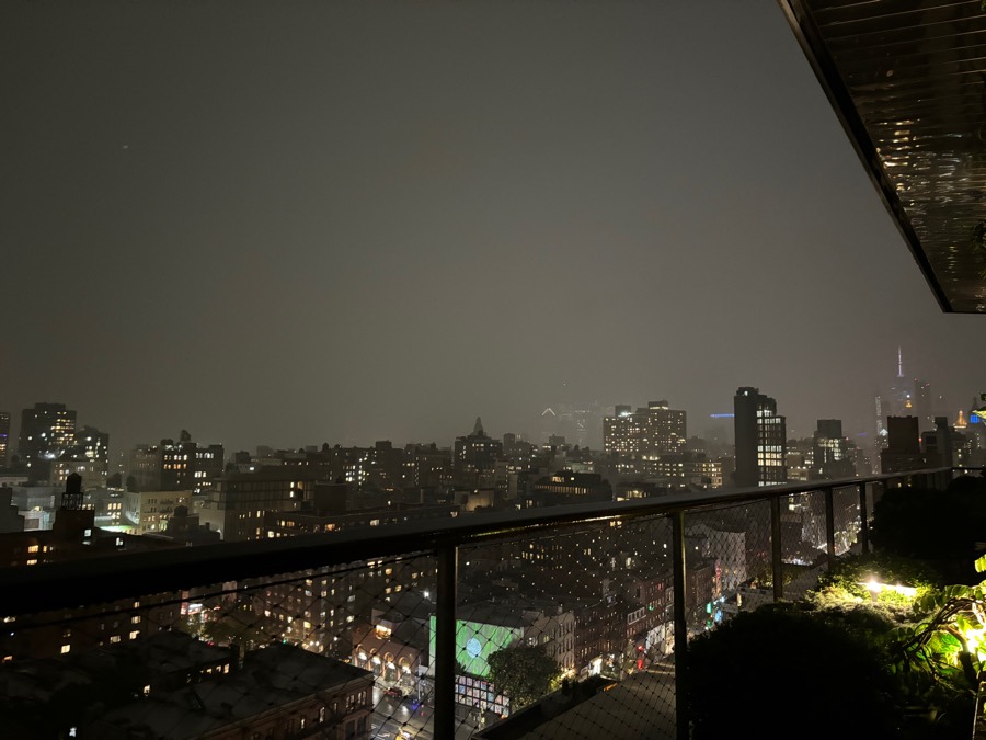 Rainy Manhattan skyline from a rooftop at night
