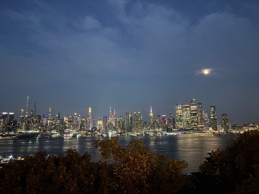 Midtown skyline across the river under the moon