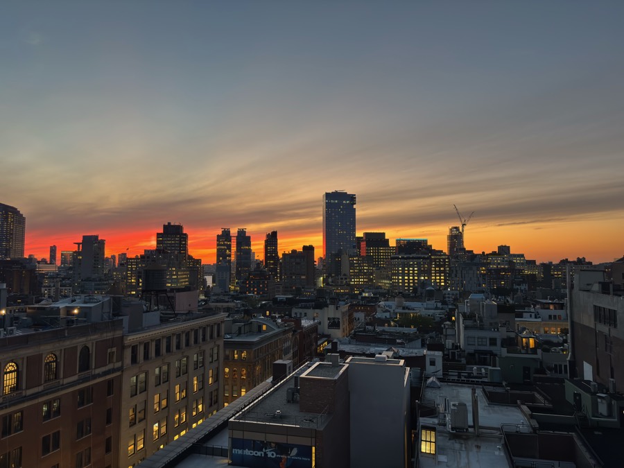 Manhattan rooftops against a vivid sunset