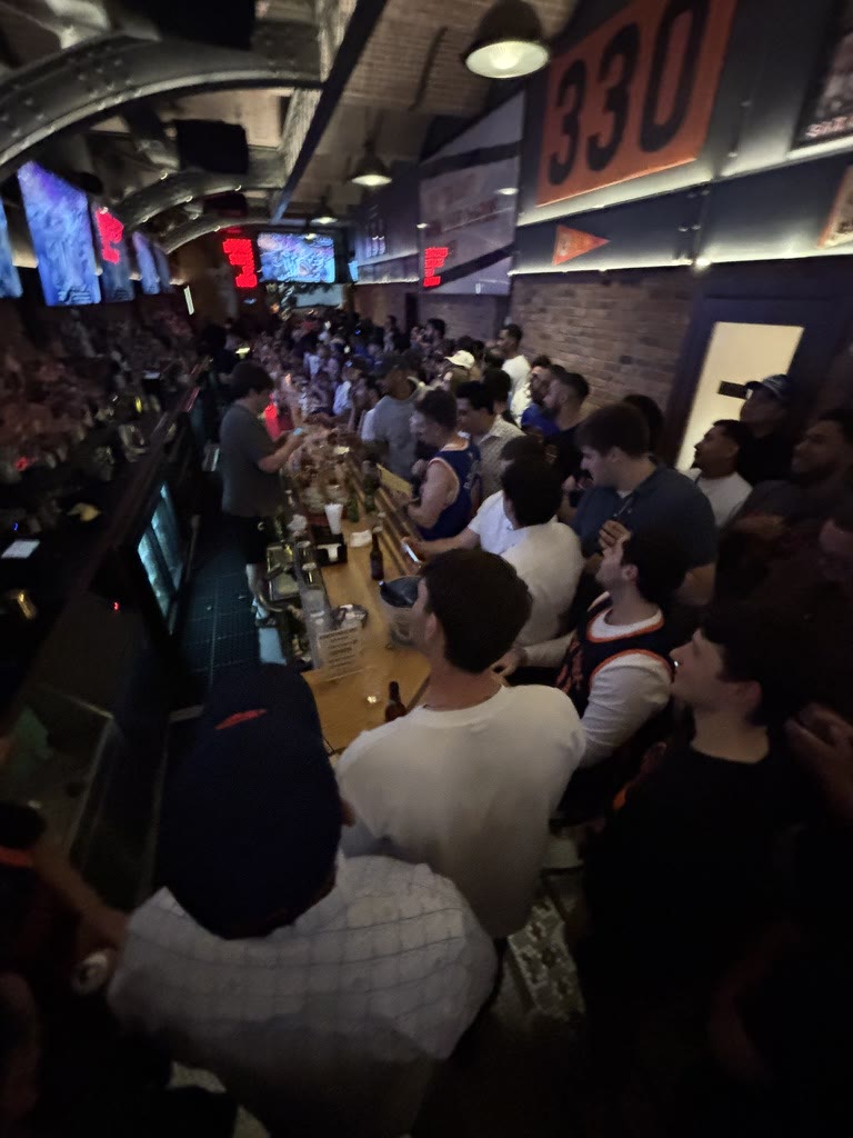 Knicks fans gathered around a crowded bar during the game