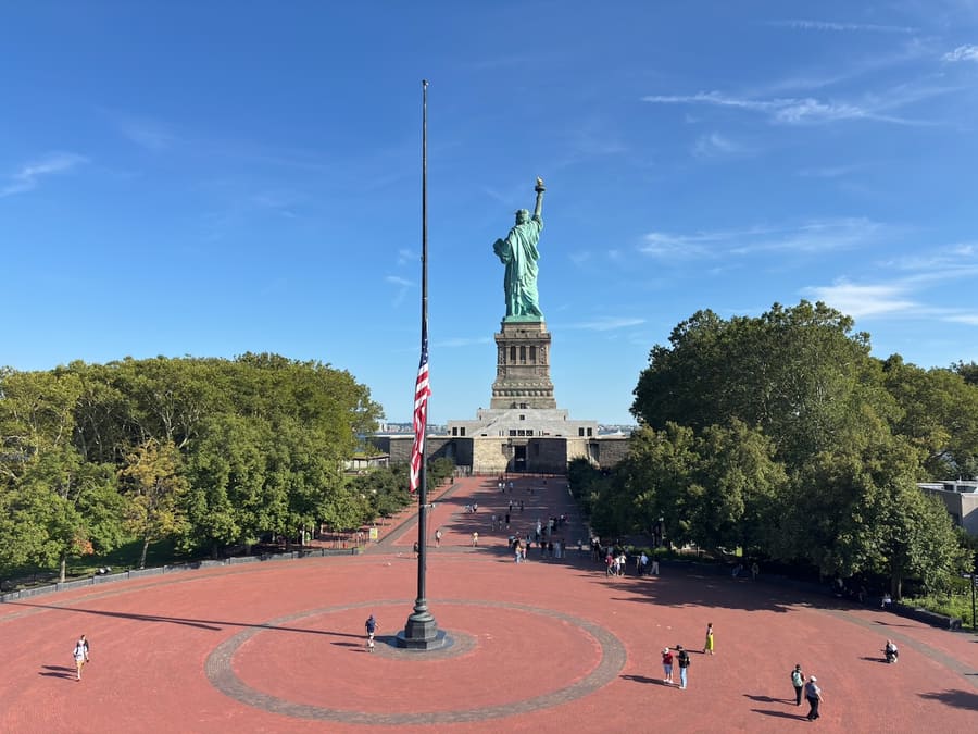 Liberty Island plaza and flagpole leading toward the Statue of Liberty