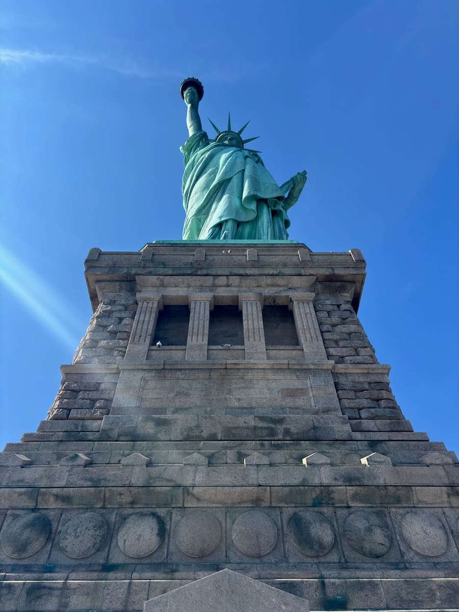 Statue of Liberty and stone pedestal viewed from below