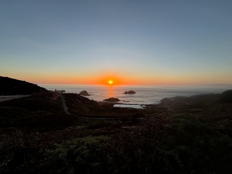 Sun setting over the Pacific Ocean and offshore rocks at Lands End on October 4, 2026