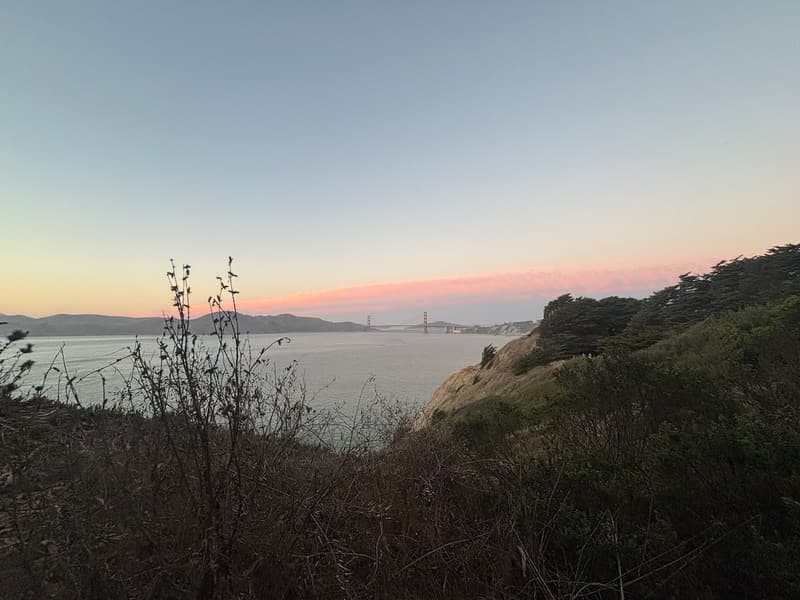 Golden Gate Bridge beneath pink clouds, viewed from Lands End on October 4, 2026