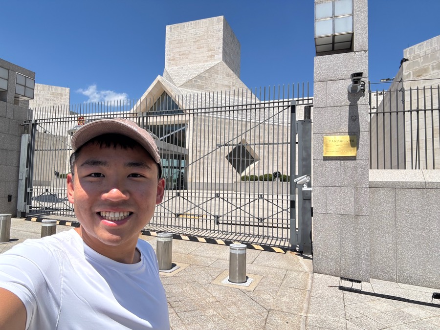 Modern embassy building behind a security fence