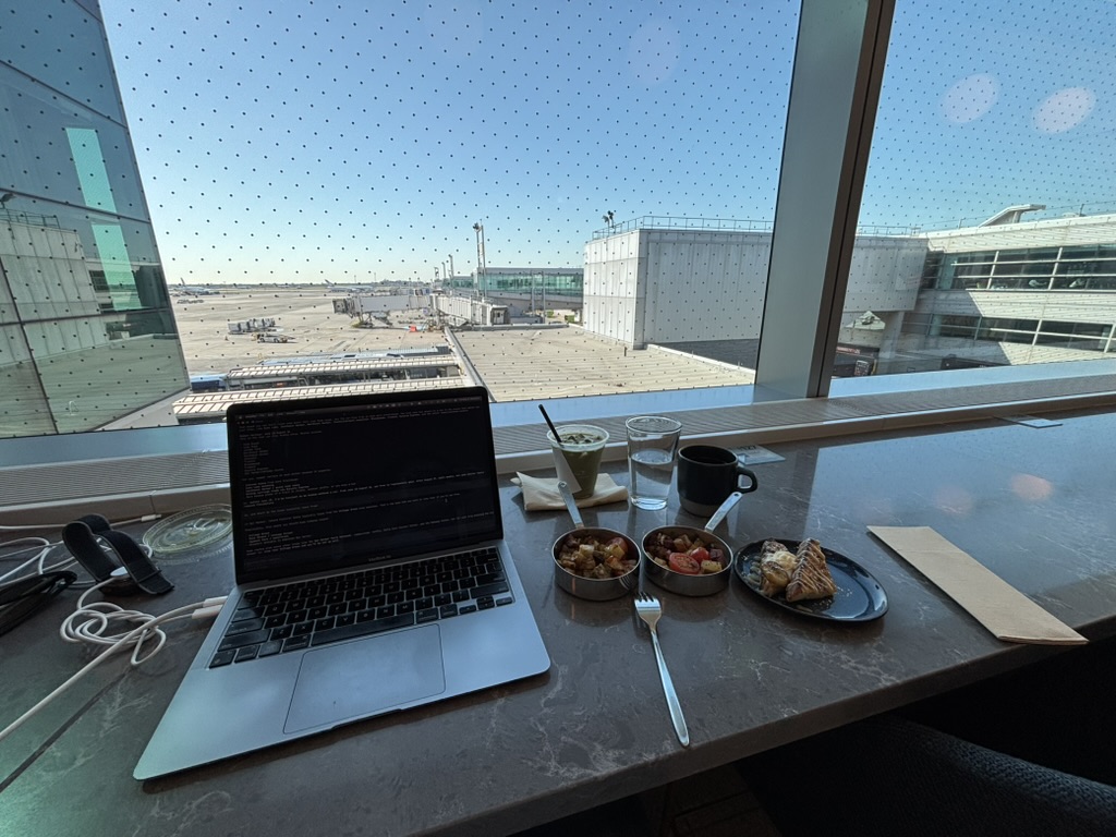 Laptop and breakfast set beside the lounge windows