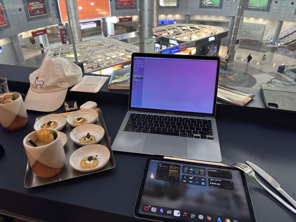 Laptop, tablet, and small plates at a window workspace